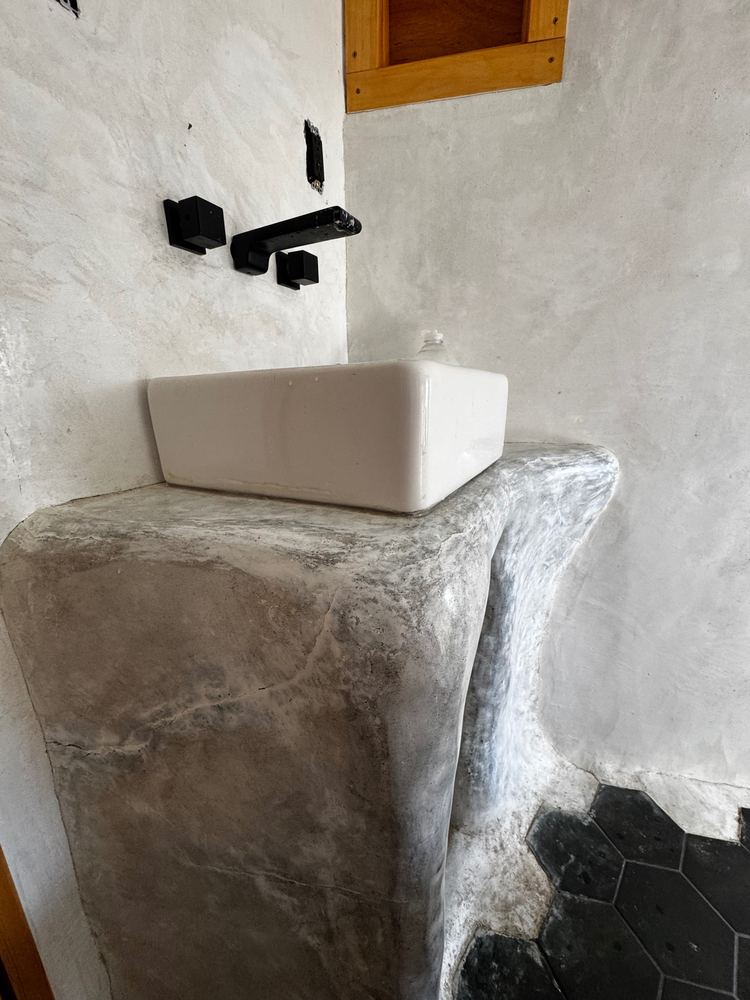 Sculpted plaster bathroom vanity at The Tavern