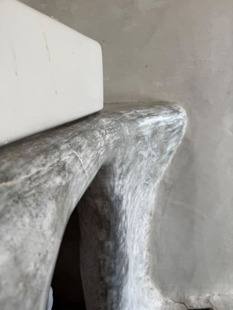 Sculpted plaster bathroom vanity at The Tavern